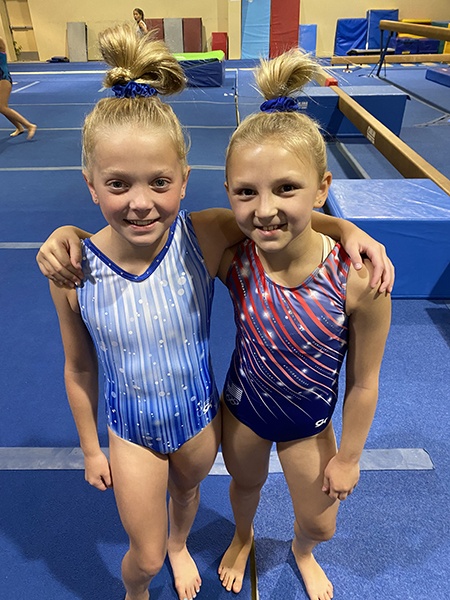 Two gymnasts smiling