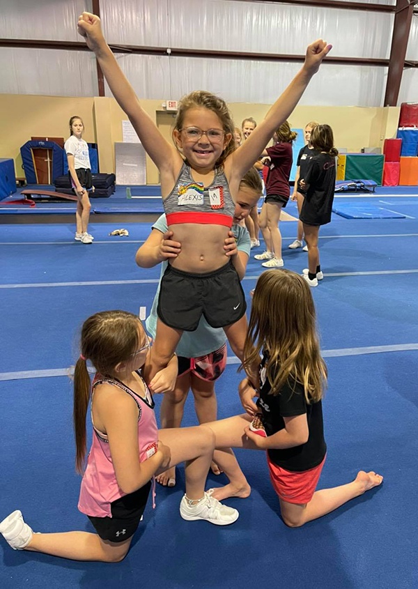Little girl on cheer team pyramid
