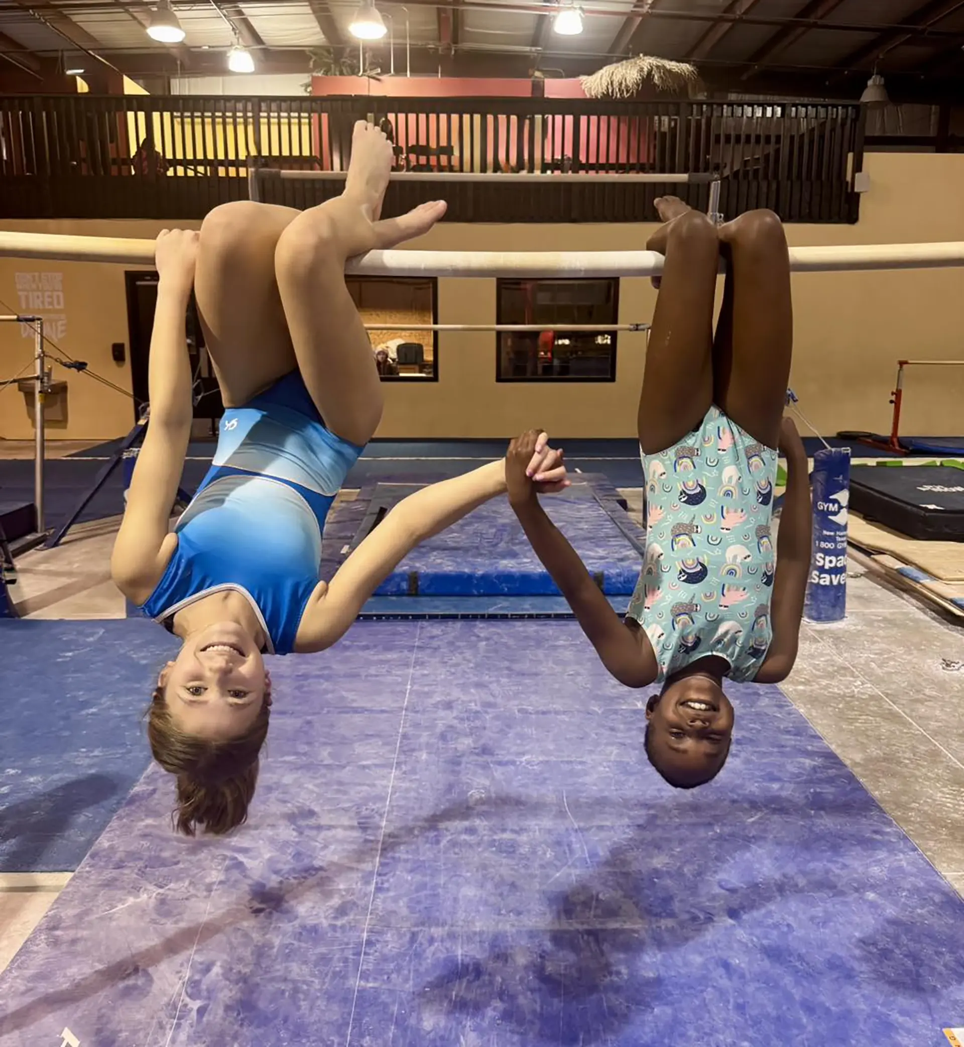Two girls hanging on bar at Siouxland Academy